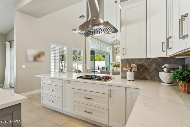 kitchen featuring stainless steel gas cooktop, island exhaust hood, decorative backsplash, white cabinets, and a peninsula