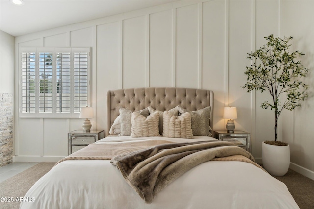 bedroom with lofted ceiling, carpet, a decorative wall, and recessed lighting