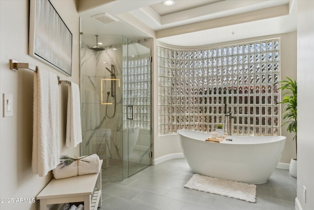 bathroom featuring a marble finish shower, recessed lighting, a soaking tub, tile patterned flooring, and baseboards