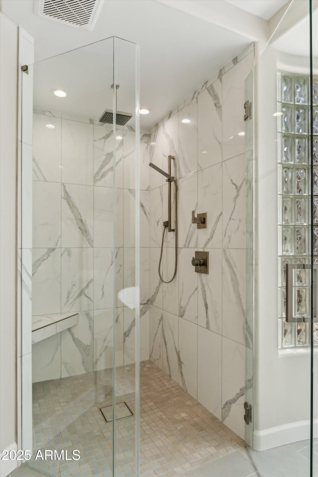 bathroom with baseboards, a marble finish shower, visible vents, and recessed lighting