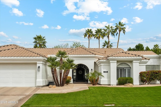 mediterranean / spanish house featuring an attached garage, a tile roof, a front lawn, and stucco siding