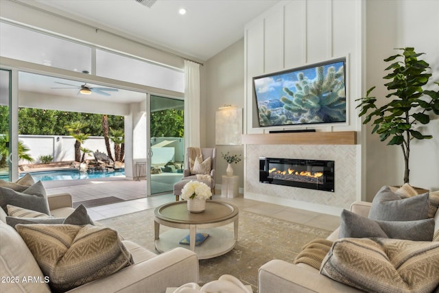 tiled living room featuring visible vents, a tile fireplace, ceiling fan, vaulted ceiling, and recessed lighting