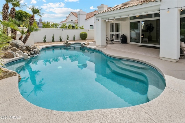 view of swimming pool featuring a patio area, fence, and a fenced in pool