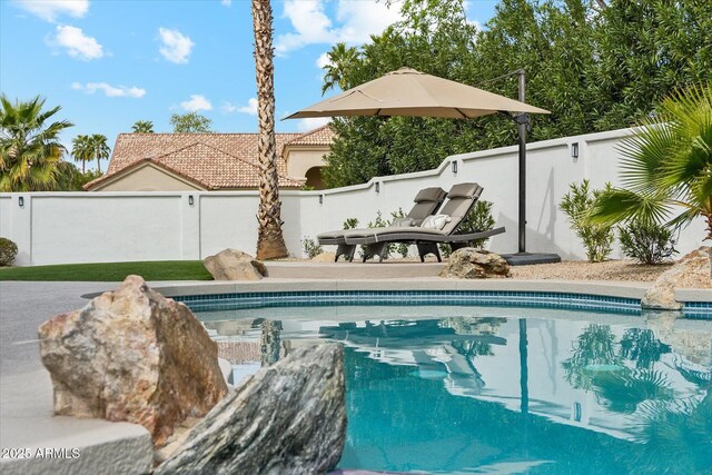 view of swimming pool with a fenced backyard and a fenced in pool