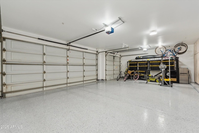 garage with freestanding refrigerator and a garage door opener