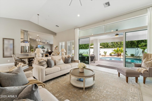 tiled living area featuring baseboards, visible vents, vaulted ceiling, and a ceiling fan