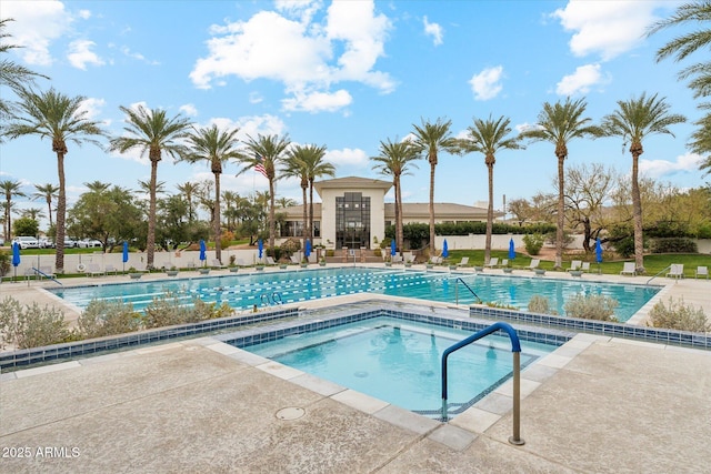 pool with a community hot tub, a patio, and fence