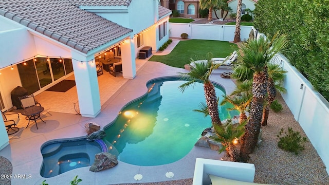 view of pool featuring an in ground hot tub, a yard, a patio area, and a fenced backyard