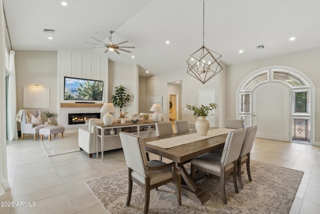 dining area featuring visible vents, a fireplace, and light tile patterned flooring