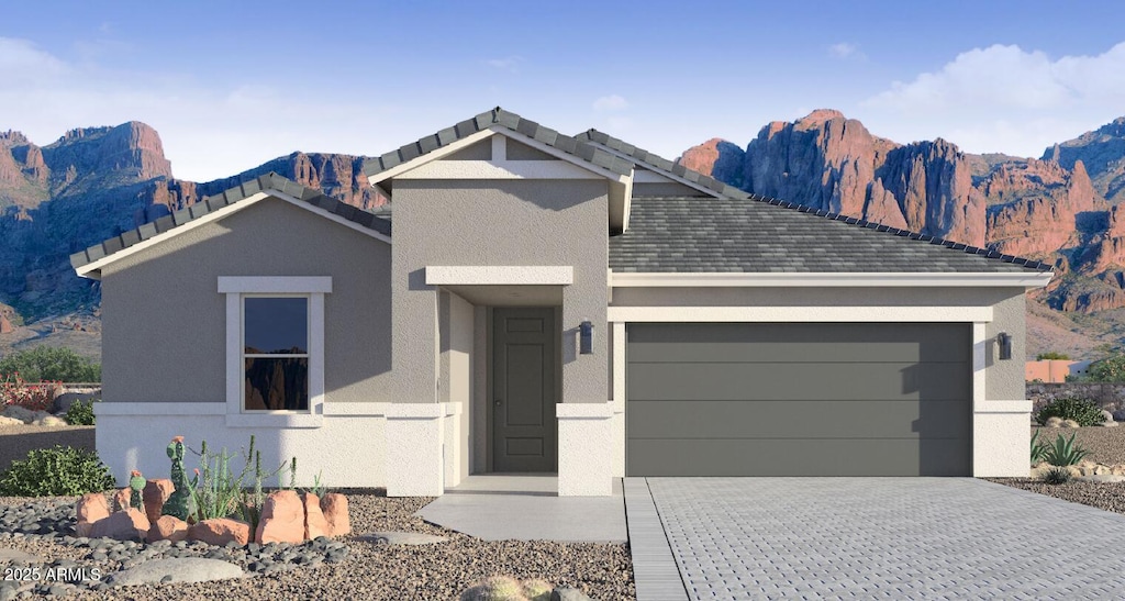 view of front facade with a mountain view and a garage