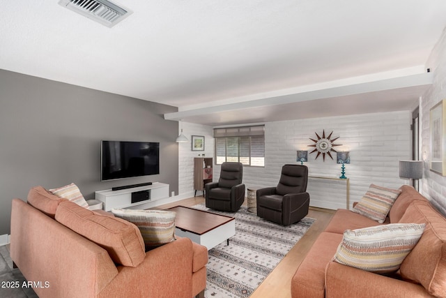 living room featuring visible vents and wood finished floors