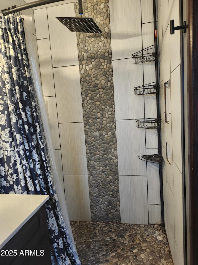 full bath with a tile shower