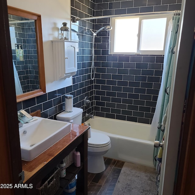 full bathroom with shower / bath combo, toilet, vanity, wood finished floors, and backsplash