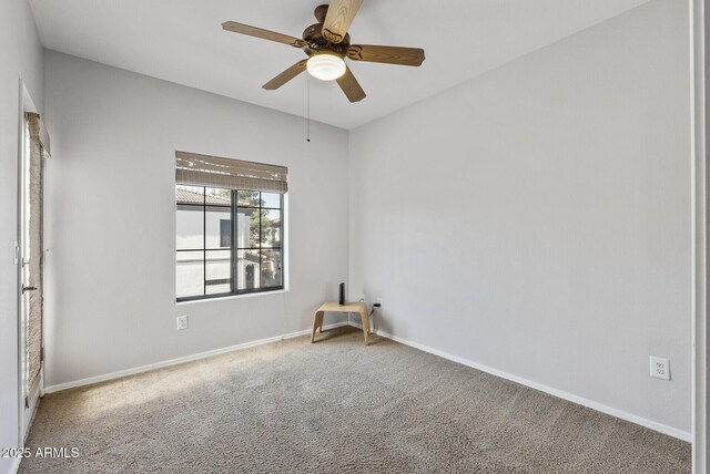 spare room featuring carpet, baseboards, and ceiling fan