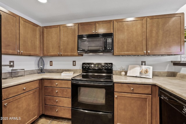 kitchen with black appliances, light countertops, and brown cabinetry