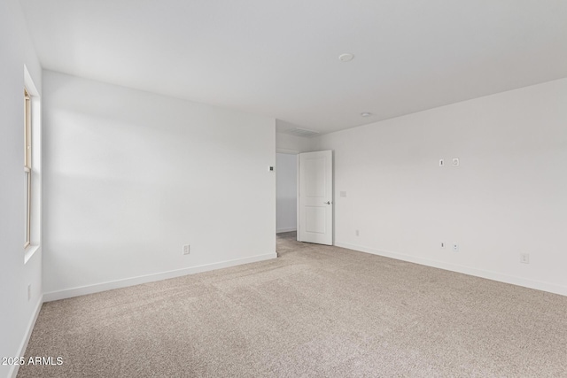 spare room with light colored carpet