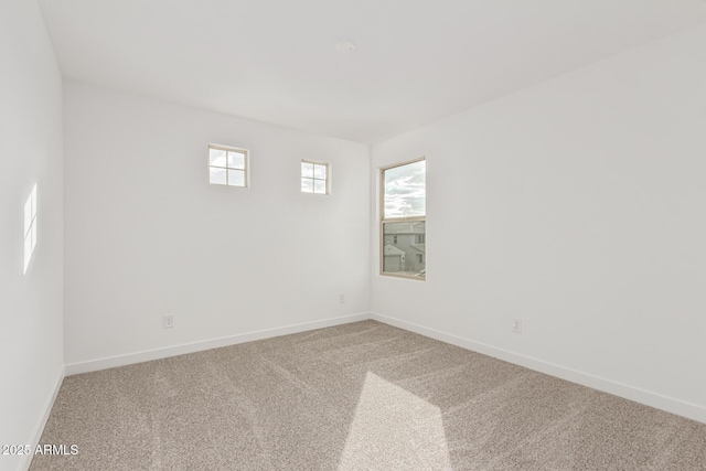 carpeted spare room with a wealth of natural light