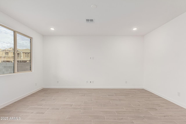 spare room with light hardwood / wood-style flooring