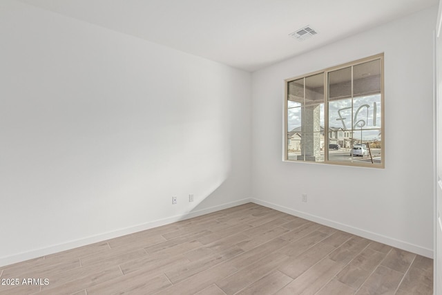 unfurnished room featuring light hardwood / wood-style floors