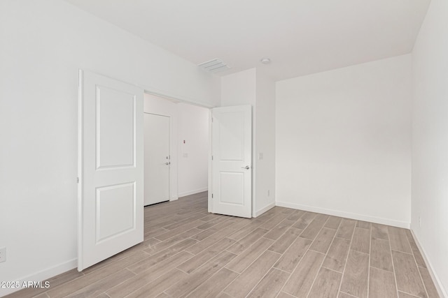 empty room with light hardwood / wood-style floors