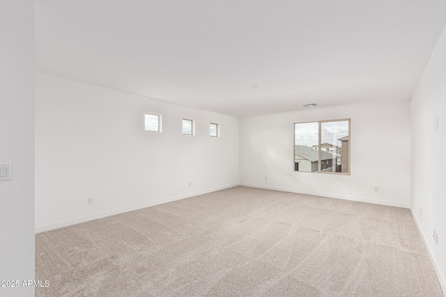 carpeted spare room featuring a wealth of natural light