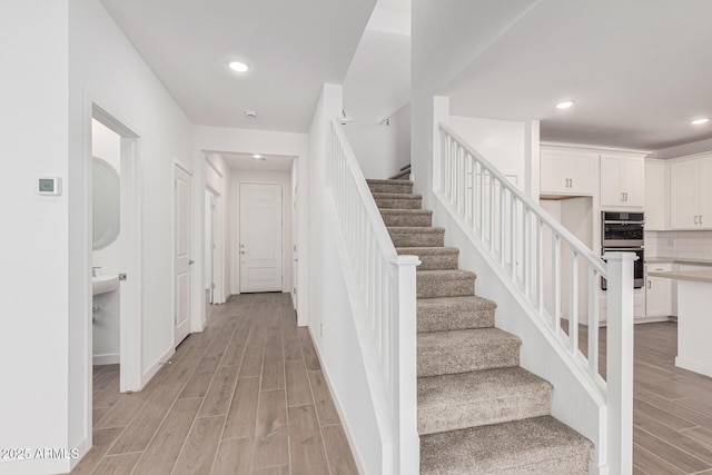 staircase featuring wood-type flooring