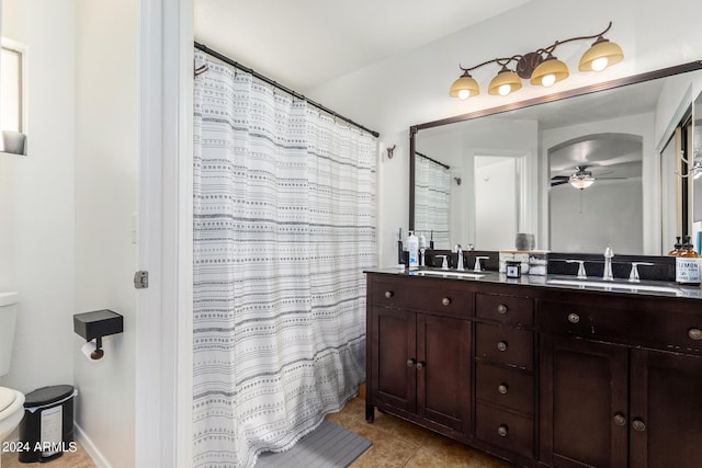 full bath with toilet, a ceiling fan, a sink, and tile patterned floors