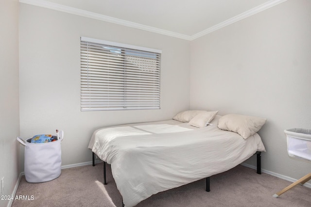 bedroom featuring crown molding, baseboards, and carpet flooring