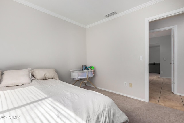 tiled bedroom with carpet floors, ornamental molding, visible vents, and baseboards