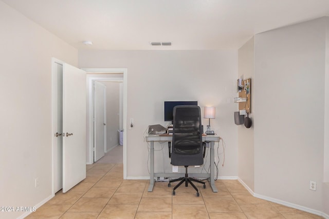 office area featuring light tile patterned floors, visible vents, and baseboards