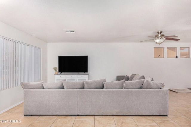 living room with light tile patterned flooring, visible vents, and a ceiling fan