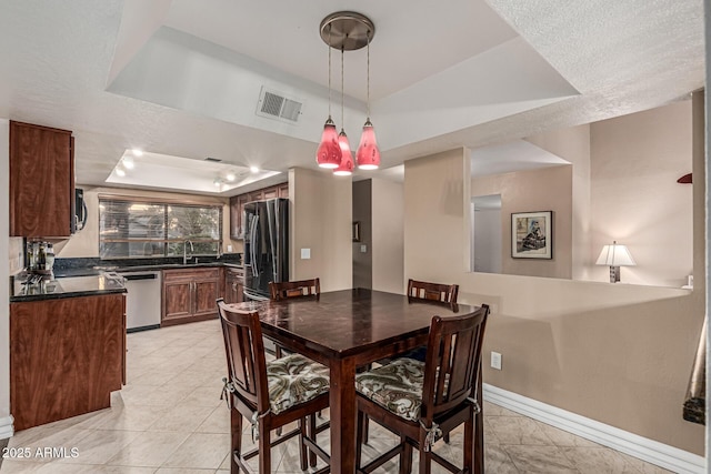 8219 E Morgan Trl, Scottsdale, AZ 85258 - dining space featuring a tray ceiling and baseboards