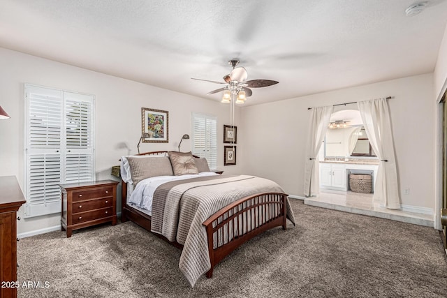 8219 E Morgan Trl, Scottsdale, AZ 85258 - carpeted bedroom with connected bathroom and a ceiling fan