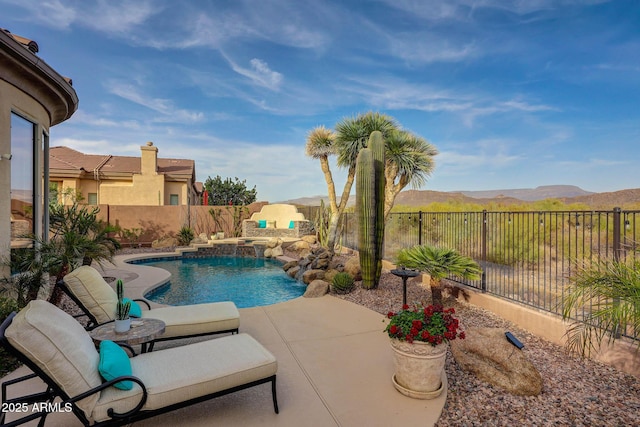 view of swimming pool with a patio, a fenced backyard, a mountain view, and a fenced in pool