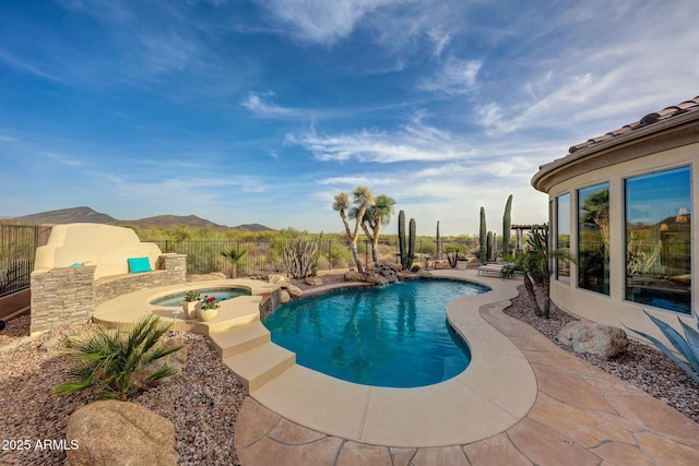 view of swimming pool with a mountain view, an in ground hot tub, fence, a fenced in pool, and a patio area