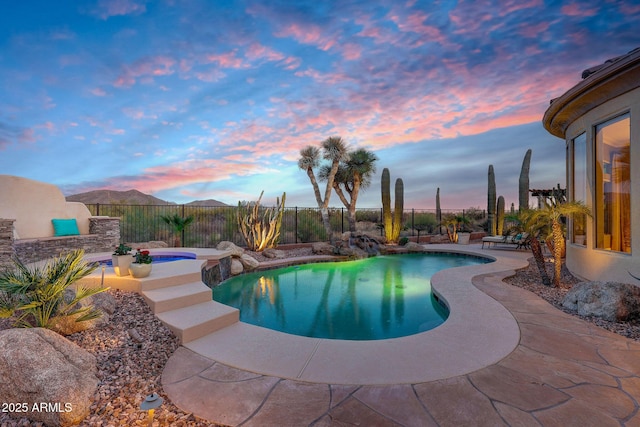 view of pool featuring a fenced in pool, a patio area, a fenced backyard, and a mountain view