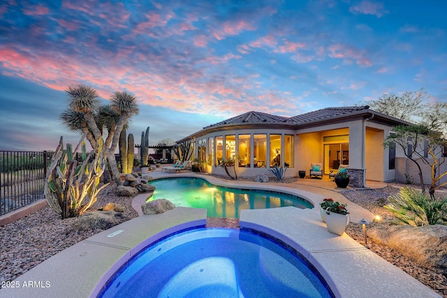 view of pool with an in ground hot tub, a patio, a fenced backyard, and a fenced in pool