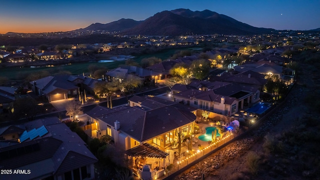 aerial view at dusk featuring a mountain view