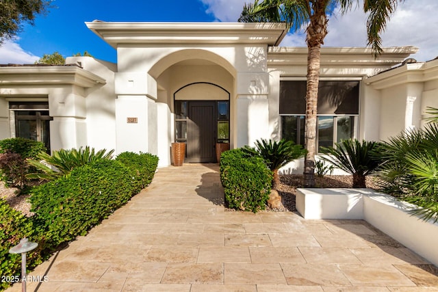 property entrance with stucco siding