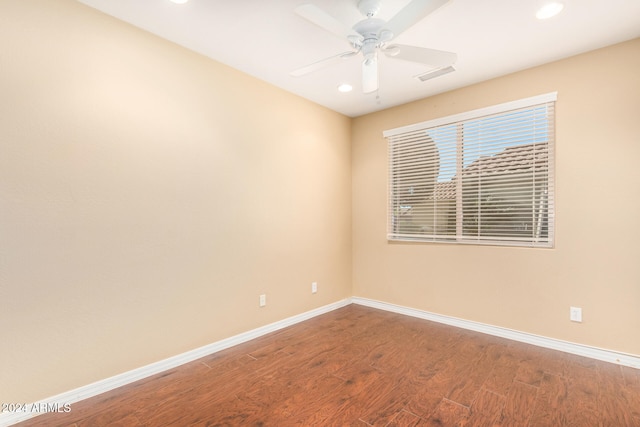 spare room with visible vents, wood finished floors, recessed lighting, baseboards, and ceiling fan