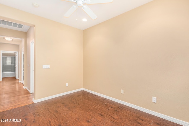 empty room with visible vents, baseboards, wood finished floors, and a ceiling fan