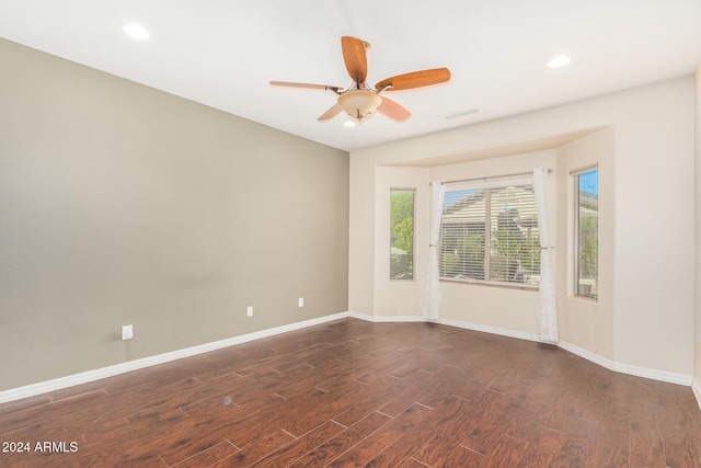 spare room with a ceiling fan, recessed lighting, dark wood-style floors, and baseboards