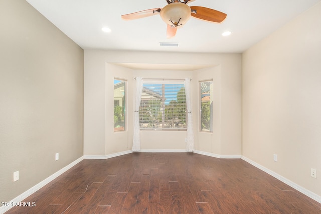 spare room with recessed lighting, visible vents, baseboards, and dark wood-style flooring