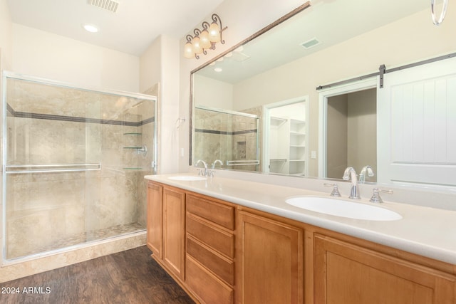 bathroom featuring a stall shower, visible vents, and a sink