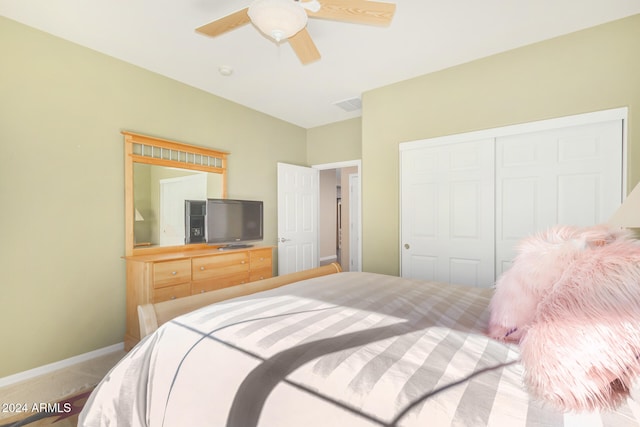 bedroom with visible vents, a ceiling fan, a closet, carpet floors, and baseboards