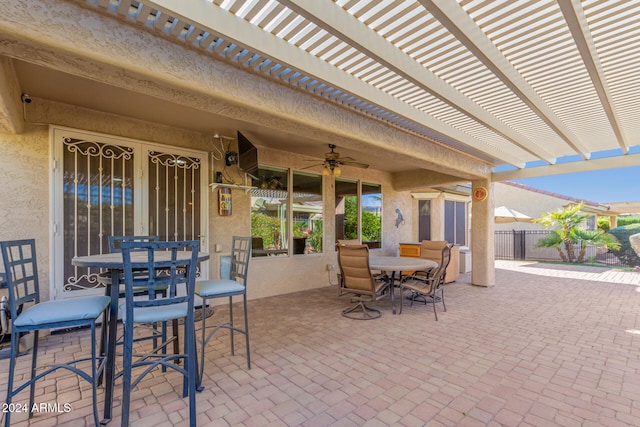 view of patio / terrace featuring a ceiling fan, outdoor dining area, fence, and a pergola