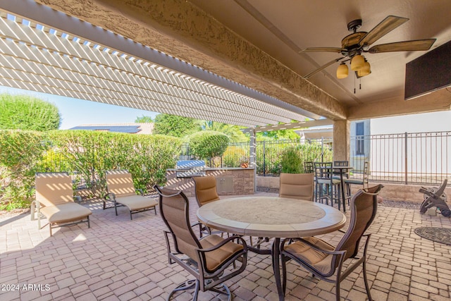 view of patio with outdoor dining space, a pergola, a ceiling fan, and fence