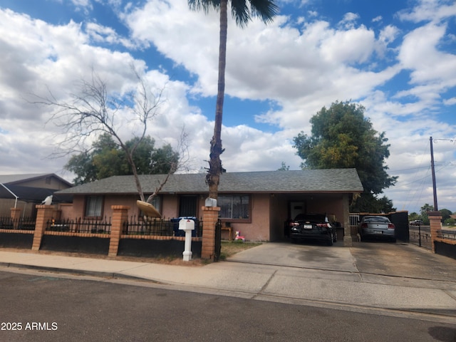 418 E Houser Ave, Buckeye, AZ 85326 - single story home with driveway, stucco siding, a fenced front yard, and an attached carport