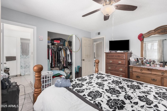 418 E Houser Ave, Buckeye, AZ 85326 - bedroom featuring light tile patterned floors, a closet, ceiling fan, and a textured ceiling