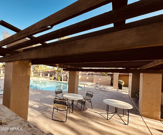 view of patio / terrace with a community pool and a pergola